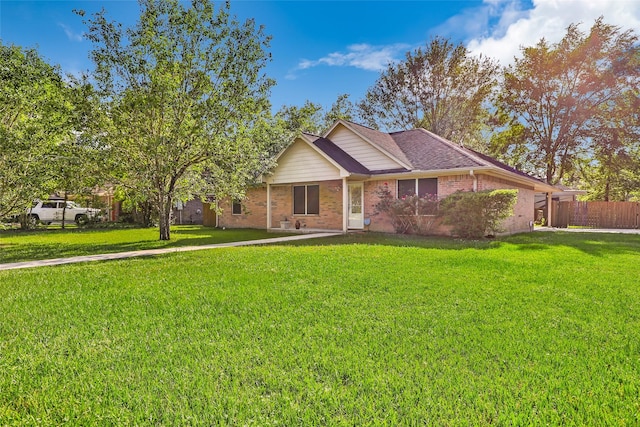 ranch-style house featuring fence, brick siding, and a front yard