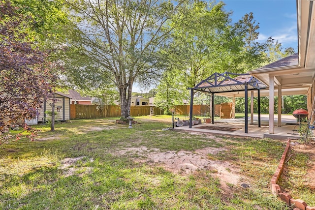 view of yard featuring a storage shed, a patio, a gazebo, and a fenced backyard