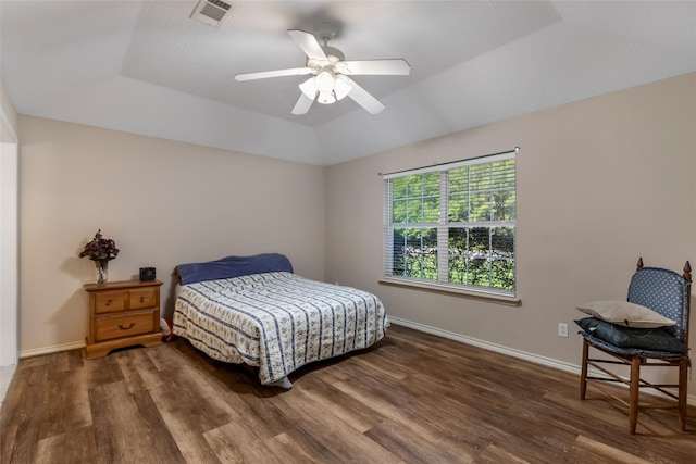 bedroom featuring baseboards, a ceiling fan, wood finished floors, and visible vents