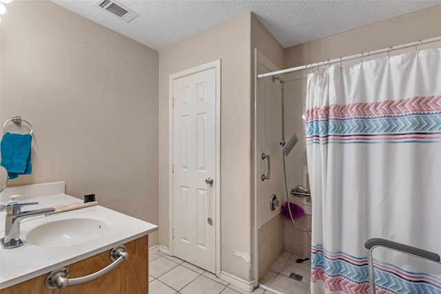 bathroom featuring tile patterned floors, a shower with shower curtain, a textured ceiling, and visible vents