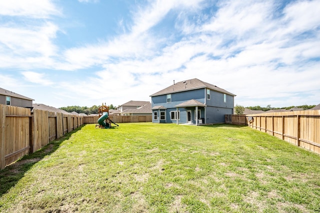 view of yard featuring a playground and a fenced backyard