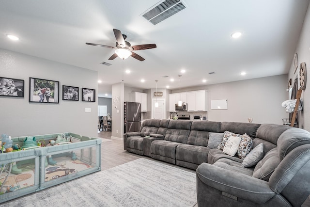 living area featuring recessed lighting, ceiling fan, visible vents, and light wood-type flooring