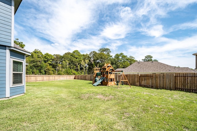 view of yard featuring a fenced backyard and a playground