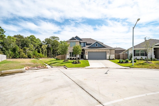 view of front of home with fence, an attached garage, a front lawn, brick siding, and concrete driveway