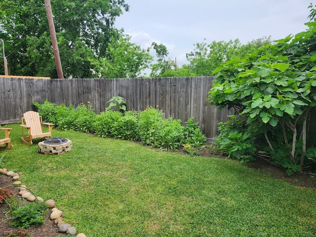 view of yard with a fenced backyard and an outdoor fire pit