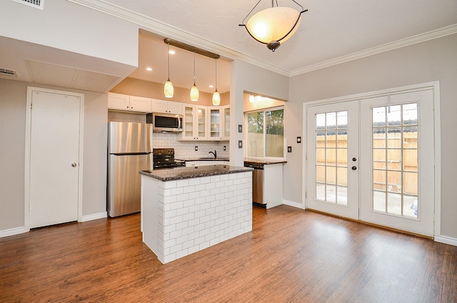 kitchen with a center island, a sink, white cabinets, dark wood-style floors, and stainless steel appliances