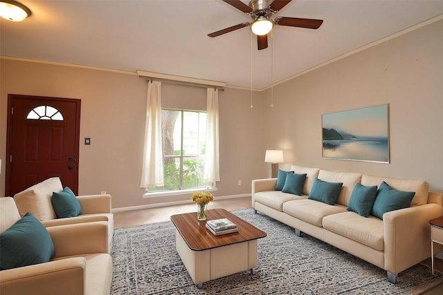 living room with carpet floors, a ceiling fan, baseboards, and crown molding