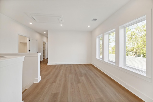 spare room with visible vents, baseboards, attic access, recessed lighting, and light wood-type flooring