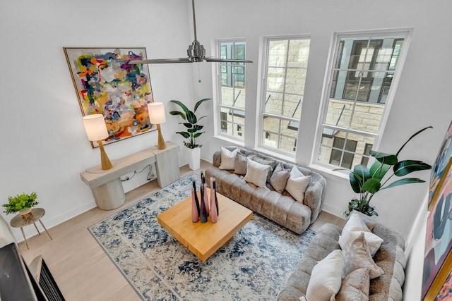 living area featuring baseboards and wood finished floors