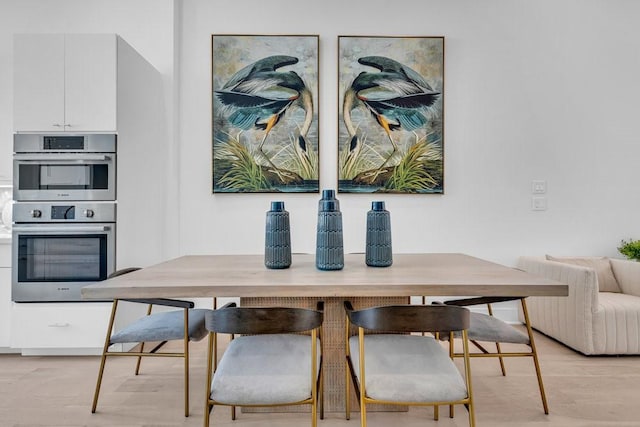 dining area featuring light wood-style flooring