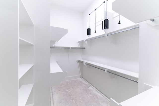 walk in closet featuring light tile patterned flooring