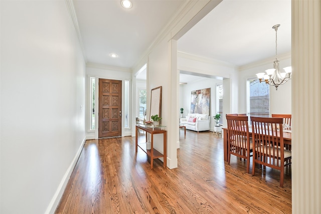 5217 Beech St, Bellaire, TX 77401 - foyer entrance with crown molding, an inviting chandelier, baseboards, light wood-type flooring, and recessed lighting