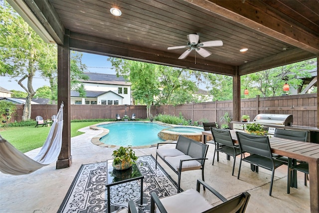 5217 Beech St, Bellaire, TX 77401 - view of swimming pool featuring grilling area, outdoor dining area, a pool with connected hot tub, a fenced backyard, and a patio