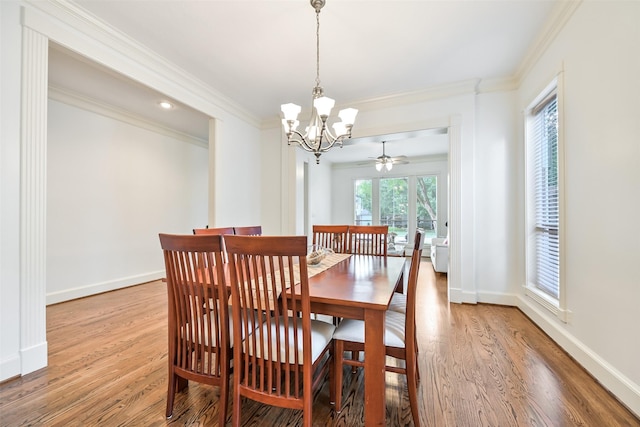 5217 Beech St, Bellaire, TX 77401 - dining space featuring baseboards, an inviting chandelier, ornamental molding, and light wood-type flooring
