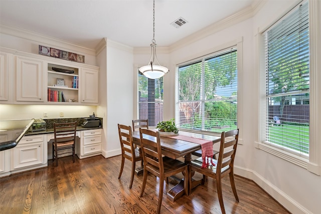 5217 Beech St, Bellaire, TX 77401 - dining space with dark wood-style flooring, visible vents, built in study area, baseboards, and ornamental molding