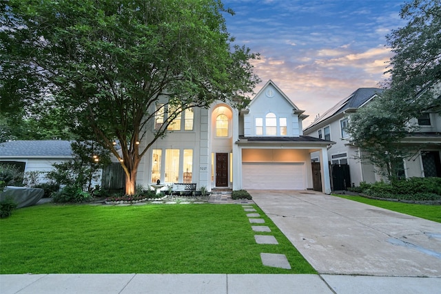 5217 Beech St, Bellaire, TX 77401 - traditional-style house with a lawn, stucco siding, an attached garage, and driveway