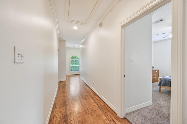 5217 Beech St, Bellaire, TX 77401 - corridor with attic access, visible vents, crown molding, baseboards, and light wood finished floors
