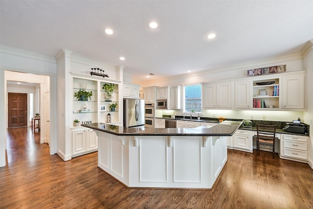 5217 Beech St, Bellaire, TX 77401 - kitchen with open shelves, appliances with stainless steel finishes, dark countertops, and ornamental molding