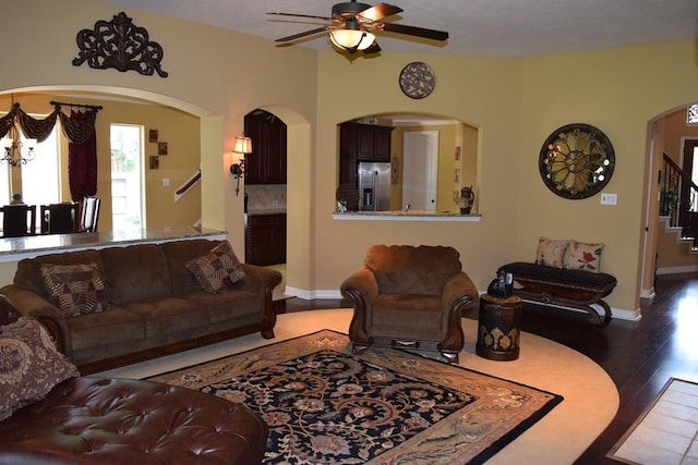 8807 Stowe Creek Ln, Missouri City, TX 77459 - living area with stairway, ceiling fan, wood finished floors, baseboards, and arched walkways