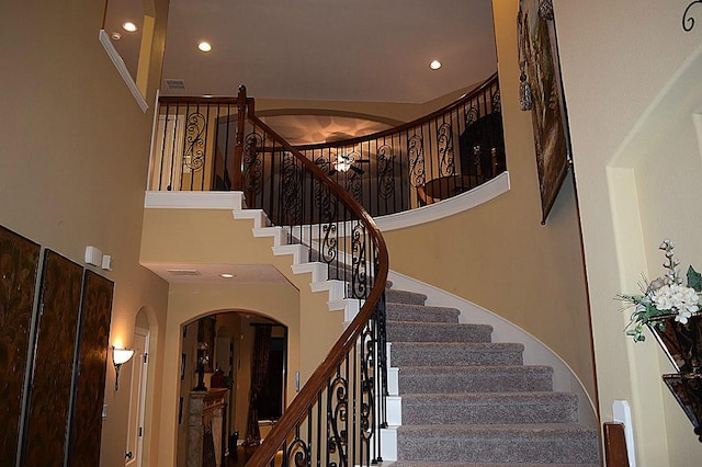 8807 Stowe Creek Ln, Missouri City, TX 77459 - stairway with a high ceiling, arched walkways, and recessed lighting