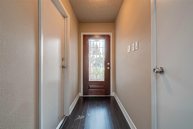 entryway with baseboards, a textured ceiling, and dark wood finished floors