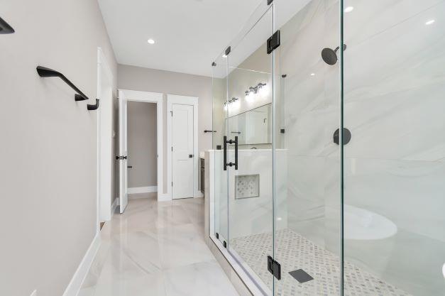 bathroom with recessed lighting, baseboards, marble finish floor, and a stall shower