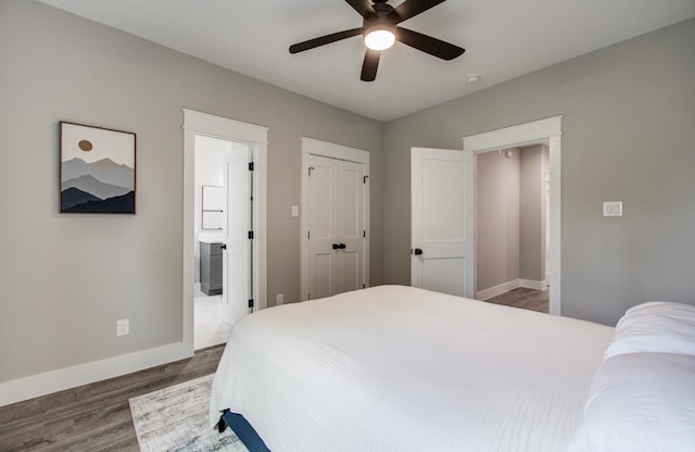 bedroom featuring baseboards, a ceiling fan, ensuite bathroom, and wood finished floors