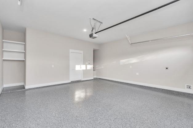 garage featuring baseboards and a garage door opener