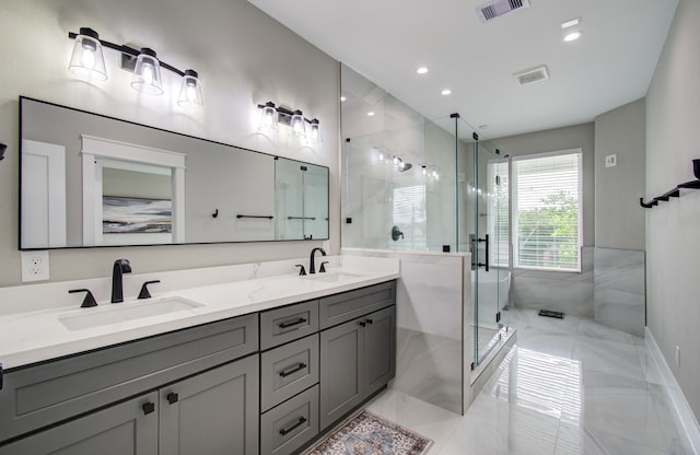 full bathroom featuring a sink, a shower stall, and visible vents