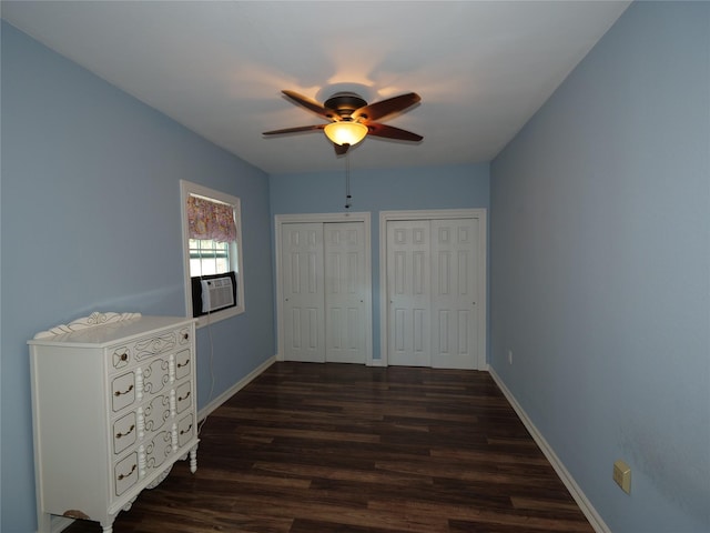 4202 Astwood Ct, Houston, TX 77068 - unfurnished bedroom with baseboards, multiple closets, dark wood finished floors, and cooling unit