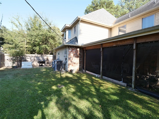 4202 Astwood Ct, Houston, TX 77068 - exterior space with fence, brick siding, a sunroom, cooling unit, and a yard