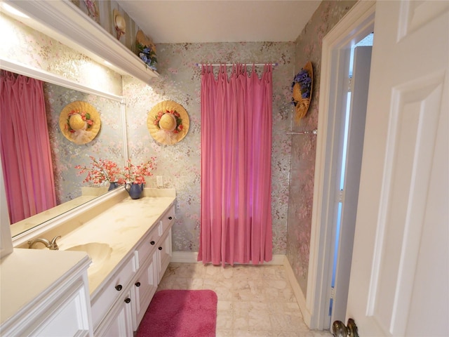 4202 Astwood Ct, Houston, TX 77068 - bathroom with vanity, baseboards, tiled shower, and wallpapered walls