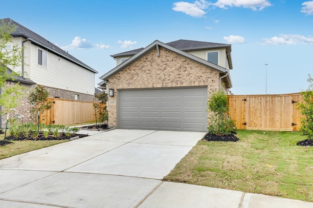 view of front of property with brick siding, fence, a front lawn, concrete driveway, and an attached garage