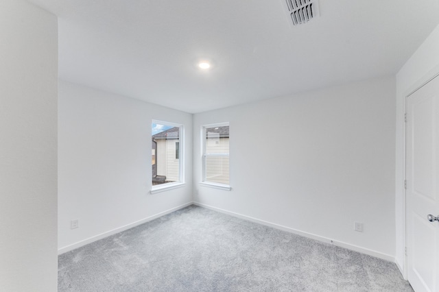 spare room featuring baseboards, carpet, and visible vents