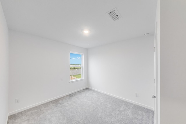 spare room with visible vents, carpet flooring, and baseboards