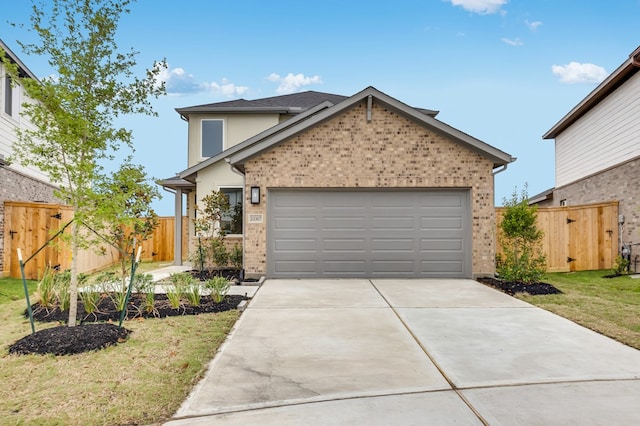 traditional-style home featuring fence, a front yard, brick siding, an attached garage, and driveway