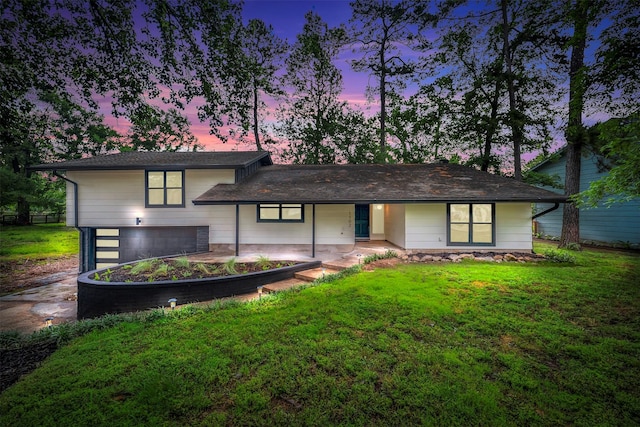 view of front facade with a garage, driveway, and a front lawn