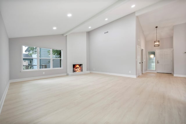 unfurnished living room featuring high vaulted ceiling, baseboards, light wood-style flooring, and visible vents