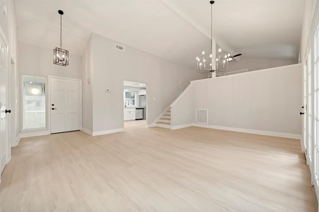 entryway featuring high vaulted ceiling, visible vents, and a chandelier