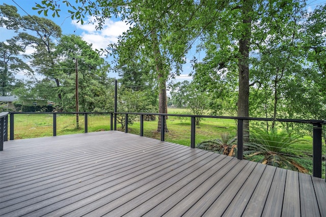 wooden deck featuring a yard