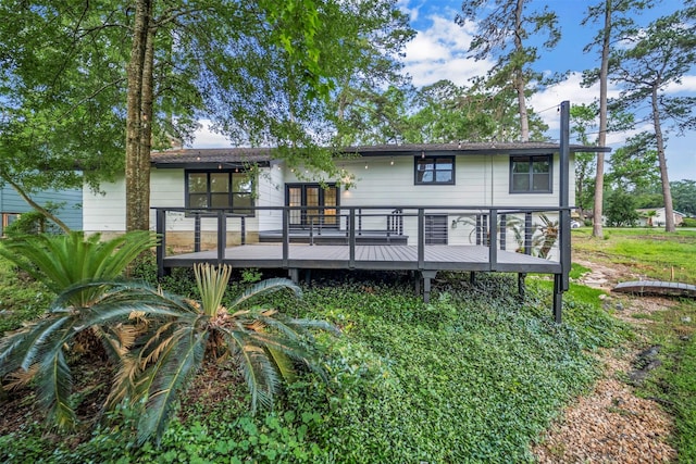 rear view of property featuring a wooden deck
