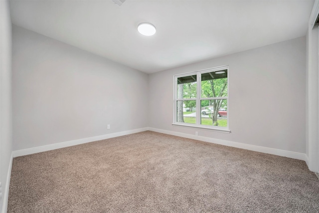empty room featuring baseboards and carpet flooring