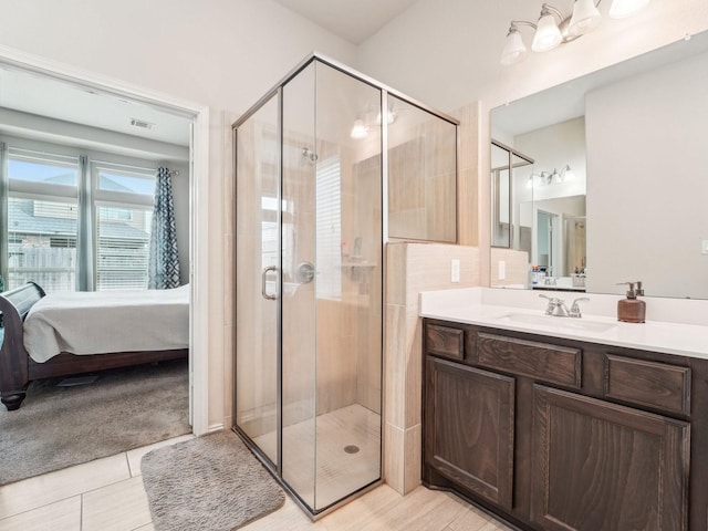 bathroom with visible vents, a stall shower, vanity, tile patterned floors, and connected bathroom