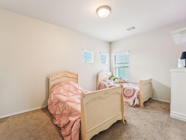bedroom featuring visible vents, carpet, and baseboards