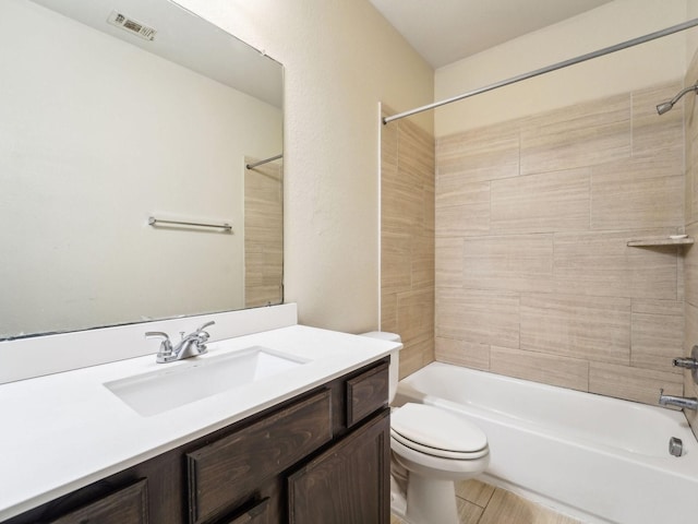 bathroom with vanity, toilet, shower / tub combination, and visible vents