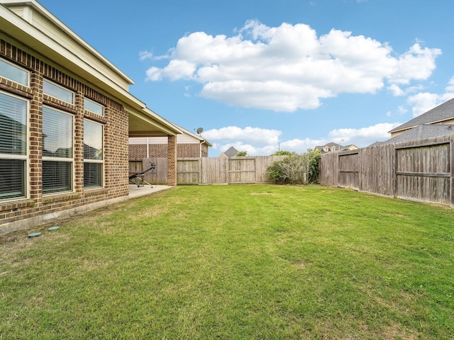 view of yard with a fenced backyard and a patio