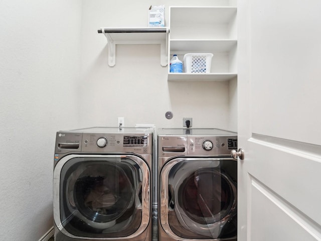 washroom with separate washer and dryer and laundry area