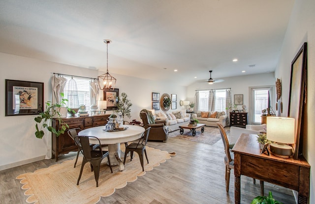 14543 Rain Tree Dr, Baytown, TX 77523 - dining space featuring recessed lighting, baseboards, ceiling fan with notable chandelier, and light wood-type flooring