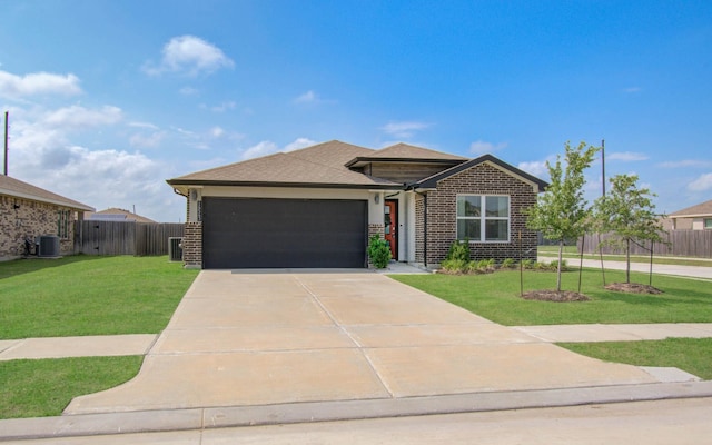 14543 Rain Tree Dr, Baytown, TX 77523 - view of front of property featuring brick siding, a garage, and a front lawn