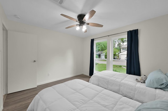 bedroom featuring baseboards, ceiling fan, and wood finished floors
